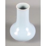 A Chinese porcelain baluster vase decorated monochrome pale blue glaze with six character Kangxi