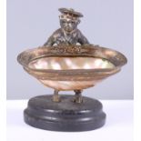 A 19th century standing salt, formed as a monkey holding a shell, with parcel gilt decoration, 3 1/