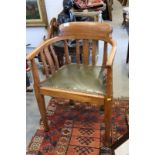 An Arts & Crafts oak lath back desk elbow chair with green leather seat, on square taper supports