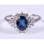 An 18ct white gold sapphire and diamond cluster ring, central sapphire 1.77ct, ring size S/T, 4.4g
