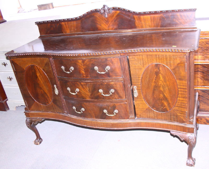 A mahogany sideboard of Georgian design fitted three drawers and cupboards