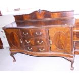 A mahogany sideboard of Georgian design fitted three drawers and cupboards