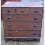 A grained as mahogany chest of three short and three long graduated drawers with ebonised knob