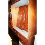 A Georgian mahogany wardrobe, the upper section enclosed two doors over two short and one long