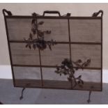 An Arts & Crafts wrought iron spark guard with floral decoration, 28" wide