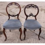 Two Victorian walnut loopback side chairs, on cabriole supports
