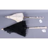 Two late 19th/early 20th century carved ivory handled lace and silk parasols, 24" and 25" long