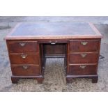 A 19th century oak double pedestal desk with inset leather top, seven graduated drawers with brass