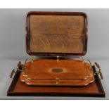 Three oak two-handled trays, various designs