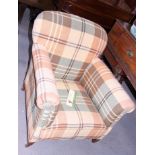 A 1920s armchair, upholstered in a checked fabric, on square taper supports
