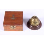 A 20th century brass cased nautical compass and a brass WWI shell timer paperweight, on stepped