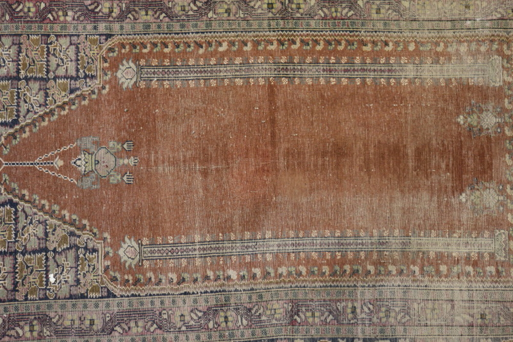 A Persian prayer rug with lantern design on a red ground and floral borders in shades of blue, red