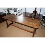 An Arts and Crafts chestnut refectory style plank top low occasional table, on stretchered supports,