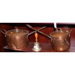 Two copper saucepans and covers and a brass hand-bell with turned wood handle