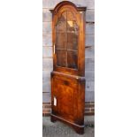 A walnut corner display cabinet of Queen Anne design, the upper section enclosed lattice glazed