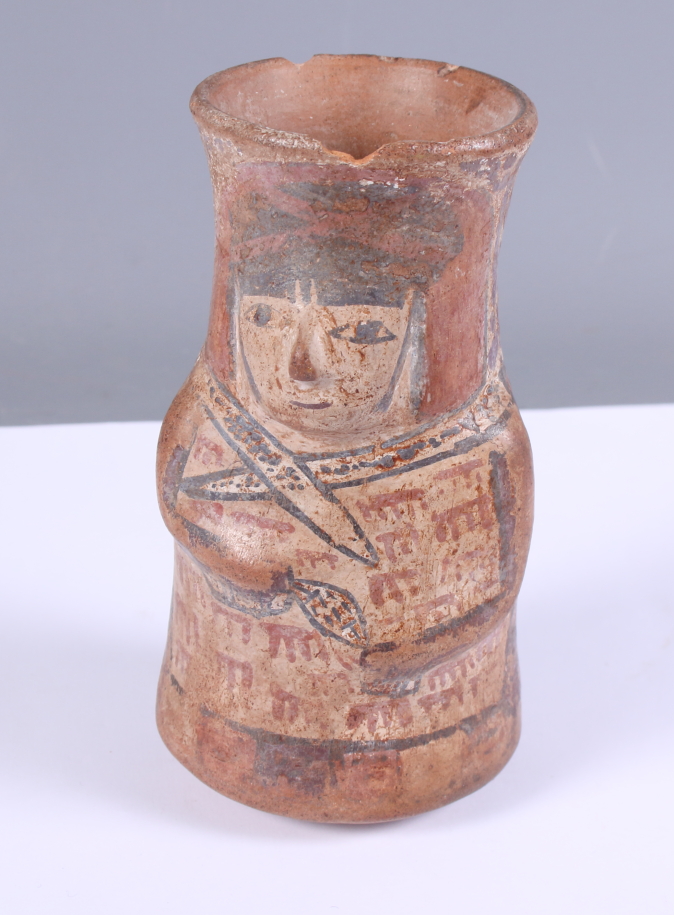 A painted Mayan terracotta vessel, moulded in the form of a man, 5" high