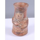 A painted Mayan terracotta vessel, moulded in the form of a man, 5" high