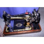 A Singer sewing machine, in arch top case
