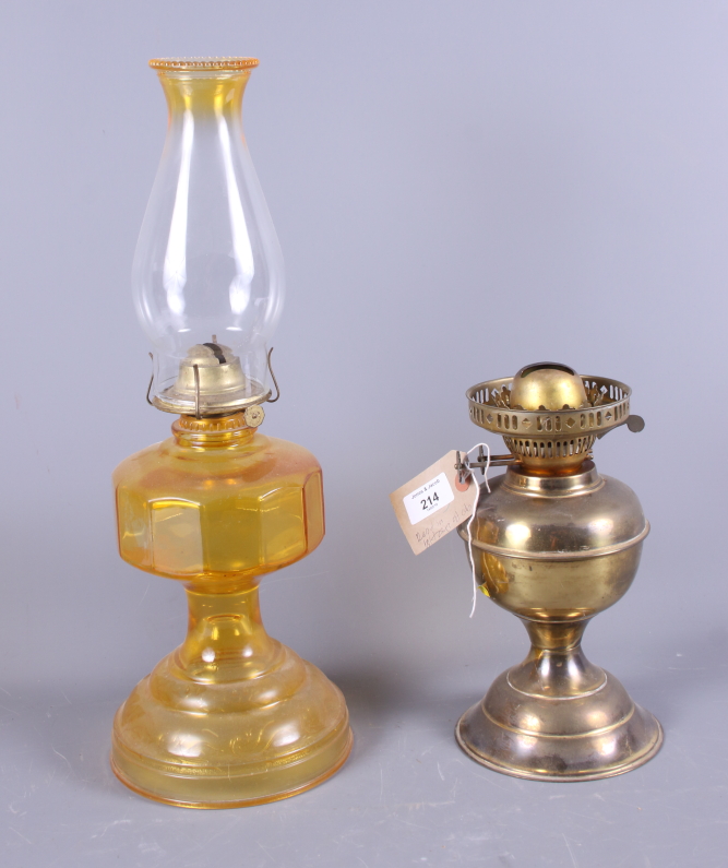 An early 20th century pressed glass oil lamp together with one other oil lamp