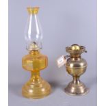 An early 20th century pressed glass oil lamp together with one other oil lamp