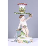 A Continental porcelain cherub candlestick with crossed sword mark and incised number 2136, 7 1/2"