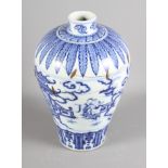 An 18th century Chinese porcelain blue and white vase, decorated figures, buildings and clouds in