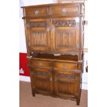 A pair of oak side cupboards, fitted two drawers over panelled doors, on stile supports, 36" wide