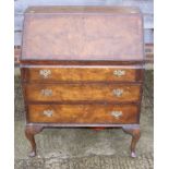 An early 20th century walnut fall front bureau, fitted three graduated drawers, on cabriole