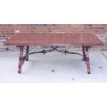 A Spanish walnut low coffee table with wrought iron stretchers, 38" x 58"