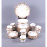 An Edwardian bone china part tea service with floral gilt decoration