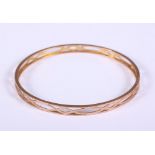 A 9ct gold bangle with pierced decoration, 14.4g