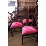 A set of four polished as mahogany hump back standard dining chairs with carved wheat sheath