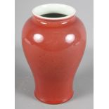 A Chinese porcelain baluster vase decorated sang de boeuf glaze, 7 1/2" high