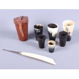A late 19th century graduated set of horn hunting beakers, in leather case, together with an ivory