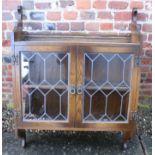 An oak wall hung display cabinet enclosed leaded glazed doors, 34 1/2" wide