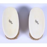 Two 19th century ivory backed grooming brushes, each with gold inserted initials, weight 348g gross