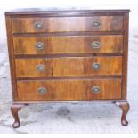 A 1930s walnut chest of four long graduated drawers, on cabriole supports, 36" wide