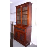 A Victorian walnut secretaire bookcase, the upper section enclosed two glazed panel doors over