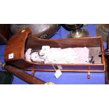 A 19th century mahogany apprentice piece doll's crib, with two early 20th century porcelain headed