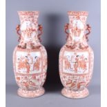 A pair of Chinese porcelain baluster vases with stylised dragon handles, decorated panels of figures