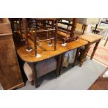 A mid 19th century mahogany extending dining table with two extra leaves, on turned and reeded