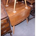 An Ercol light elm drop leaf dining table, on splay supports, 54" wide, and a matching set of four