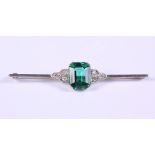 An Art Deco platinum? bar brooch, set central chrome tourmaline, 4.76ct approx, flanked six