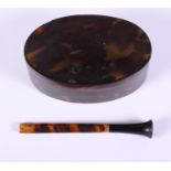 An oval tortoiseshell trinket box and cover, 3 1/2" wide, and a tortoiseshell cigarette holder, 3