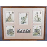 A set of five Royal mail stamps, British wildlife, and matching postcards, in strip frame