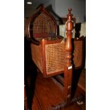 A 19th century mahogany framed cradle with caned sides and hood, on mahogany stand