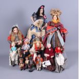 An early 20th century Spanish costume doll together with other costume dolls