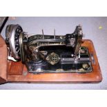 A 1910 model Frister & Rossmann sewing machine, in a walnut and Tunbridge banded case