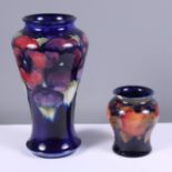 An early 20th century Moorcroft pottery "Pansy" vase on a midnight blue ground, 7" high, together