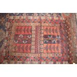 A Hatchli rug with hooked panels on a plum ground and multi-bordered in shades of red, blue, brown